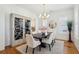 Bright dining room with modern chandelier, white walls, and an elegant china cabinet at 3858 Sawyers Island Dr, Mount Pleasant, SC 29466