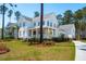 Charming two-story home with a welcoming front porch, well-manicured lawn, and beautiful landscaping at 3858 Sawyers Island Dr, Mount Pleasant, SC 29466