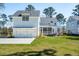 Charming two-story home with a well-manicured lawn and an attached two-car garage at 3858 Sawyers Island Dr, Mount Pleasant, SC 29466