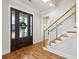 Bright foyer with hardwood floors, a modern staircase, and a stylish front door with glass panels at 3858 Sawyers Island Dr, Mount Pleasant, SC 29466