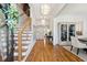 Elegant foyer with hardwood floors, a staircase with metal railings, and a view into the dining and living areas at 3858 Sawyers Island Dr, Mount Pleasant, SC 29466
