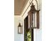 Close-up view of elegant outdoor lanterns and a decorative wreath on the front door at 3858 Sawyers Island Dr, Mount Pleasant, SC 29466