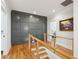 Hallway landing with wood floors, wainscoting wall detail, and a unique cable railing system at 3858 Sawyers Island Dr, Mount Pleasant, SC 29466