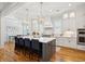 Stylish kitchen boasts a large island with seating, pendant lighting, and modern white cabinetry at 3858 Sawyers Island Dr, Mount Pleasant, SC 29466