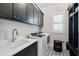 Modern laundry room with black cabinets, stylish tile floors, and new washer and dryer at 3858 Sawyers Island Dr, Mount Pleasant, SC 29466