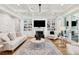 Inviting living room with a fireplace, custom shelving, and hardwood floors at 3858 Sawyers Island Dr, Mount Pleasant, SC 29466