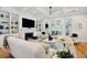 Bright living room with fireplace, custom built-ins, and floor-to-ceiling windows at 3858 Sawyers Island Dr, Mount Pleasant, SC 29466