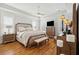 Spacious main bedroom suite with hardwood floors, sitting area, tray ceiling, and neutral color palette at 3858 Sawyers Island Dr, Mount Pleasant, SC 29466