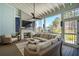 Screened porch with fireplace, ceiling fan, and comfortable wicker furniture overlooking a beautiful yard at 3858 Sawyers Island Dr, Mount Pleasant, SC 29466