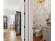 Powder room with striking wallpaper, wainscoting, marble countertop and gold mirror at 3858 Sawyers Island Dr, Mount Pleasant, SC 29466