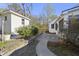 Charming backyard has a concrete walkway and lush landscaping at 418 Geddes Ave, Charleston, SC 29407