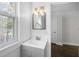 Bathroom with a white vanity, bright lighting, and beadboard detail at 418 Geddes Ave, Charleston, SC 29407