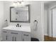 Bathroom features a modern vanity, updated mirror, and tile and glass shower stall at 418 Geddes Ave, Charleston, SC 29407