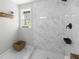 Bathroom features a tiled shower, white walls and window with greenery views at 418 Geddes Ave, Charleston, SC 29407
