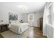 Bedroom with neutral colors, hardwood floors, large window, rug, and soft, natural light at 418 Geddes Ave, Charleston, SC 29407