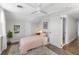 Bright bedroom features a patterned rug, built-in shelves, and access to the hall at 418 Geddes Ave, Charleston, SC 29407