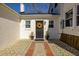 Paver walkway to back entrance featuring a black door with a decorative wreath and potted plants at 418 Geddes Ave, Charleston, SC 29407
