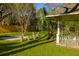 Gazebo in backyard surrounded by lush green grass and beautiful trees at 418 Geddes Ave, Charleston, SC 29407