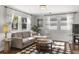 Comfortable living room with a sectional sofa, wood floors, and sunny windows with sheer curtains at 418 Geddes Ave, Charleston, SC 29407