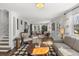 Spacious living room with hardwood floors, a fireplace, comfortable seating, and lots of natural light at 418 Geddes Ave, Charleston, SC 29407