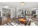 Bright living room with hardwood floors, neutral furniture, and a glimpse of the kitchen and staircase at 418 Geddes Ave, Charleston, SC 29407