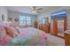Well-lit bedroom featuring a plush bed, window, ceiling fan, and wooden furniture at 430 Eastern Pine Dr, Summerville, SC 29486