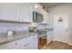 A well-equipped kitchen with white cabinets, granite counters, and stainless steel appliances at 430 Eastern Pine Dr, Summerville, SC 29486