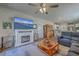 Inviting living room featuring a fireplace, TV, comfortable seating, and an open floor plan to the kitchen at 430 Eastern Pine Dr, Summerville, SC 29486
