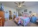 Well-lit main bedroom featuring a plush bed, ceiling fan, ensuite bathroom, and ample closet space at 430 Eastern Pine Dr, Summerville, SC 29486