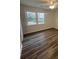 Bright bedroom featuring hardwood floors, a ceiling fan and a window to the backyard at 431 Otis Rd, Walterboro, SC 29488