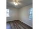 A bright bedroom with two windows and hardwood floors offers a cozy living space at 431 Otis Rd, Walterboro, SC 29488