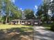 Charming single-story brick home with a well-manicured lawn, driveway, and beautiful landscaping at 431 Otis Rd, Walterboro, SC 29488