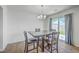 Dining room with wood floors, an elegant light fixture, and sliding glass doors at 436 Thoroughbred Dr, Moncks Corner, SC 29461