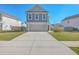 Inviting two-story home with a large driveway and a well-manicured lawn at 436 Thoroughbred Dr, Moncks Corner, SC 29461