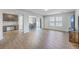 Open-concept living room with hardwood floors, large windows, and ample natural light at 436 Thoroughbred Dr, Moncks Corner, SC 29461