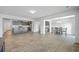 Open-concept living area with gray wood floors connecting the kitchen and dining room at 436 Thoroughbred Dr, Moncks Corner, SC 29461