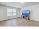 Bright living room featuring hardwood floors, large windows, and a modern entertainment center at 436 Thoroughbred Dr, Moncks Corner, SC 29461