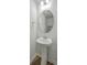 Cozy powder room featuring a pedestal sink, round mirror and modern light fixture at 436 Thoroughbred Dr, Moncks Corner, SC 29461