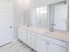 Bathroom featuring dual sinks, white cabinetry, marble floor, and a large mirror reflecting the shower at 444 Parish Farm Dr, Summerville, SC 29486