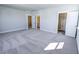 Large carpeted bedroom with three doorways, one leading to a closet space at 444 Parish Farm Dr, Summerville, SC 29486