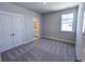 Bedroom with carpet, closet doors, and a window with outside view at 444 Parish Farm Dr, Summerville, SC 29486