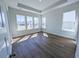 Spacious bedroom with hardwood floors, tray ceiling, and abundant natural light at 444 Parish Farm Dr, Summerville, SC 29486