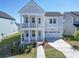 Charming two-story home with a welcoming front porch and attached two-car garage at 444 Parish Farm Dr, Summerville, SC 29486