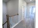 Upstairs hallway with carpet and a wood banister leading to bedrooms at 444 Parish Farm Dr, Summerville, SC 29486