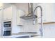 Modern kitchen with stainless steel appliances, white cabinets, and a stylish faucet at 444 Parish Farm Dr, Summerville, SC 29486