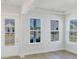 A view from a living room highlighting its door, windows, hardwood floor, and bright, neutral palette at 444 Parish Farm Dr, Summerville, SC 29486