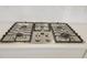 Close-up of a sleek stainless steel gas stove top set on white countertops at 444 Parish Farm Dr, Summerville, SC 29486