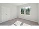 Bedroom with neutral walls and carpet, view of the lake and trees through double windows at 475 Queenview Ln, Charleston, SC 29414