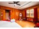 Bedroom with wood walls and floors, and a movie theme that includes red curtains and a popcorn sign at 5040 Lancaster St, North Charleston, SC 29405
