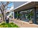 Modern storefront with large windows, plants in pots and sidewalk seating under a sunny sky at 5040 Lancaster St, North Charleston, SC 29405